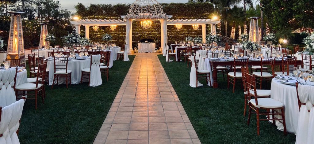 Outdoor wedding reception with fairy lights around